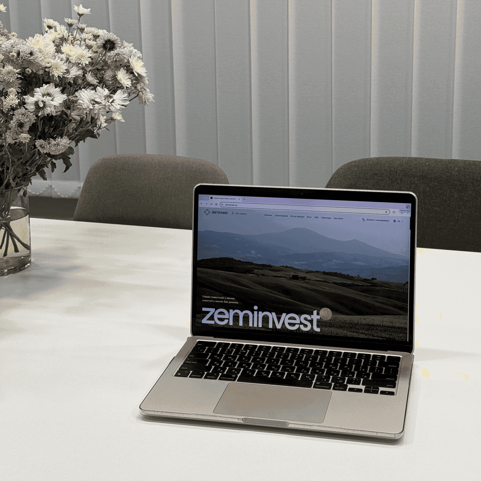 laptop on the table with main page zeminvest site merged