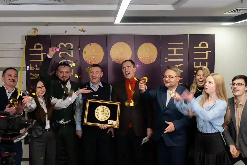 Group celebrating with confetti while holding a "No. 1 Choice of the Year" award.